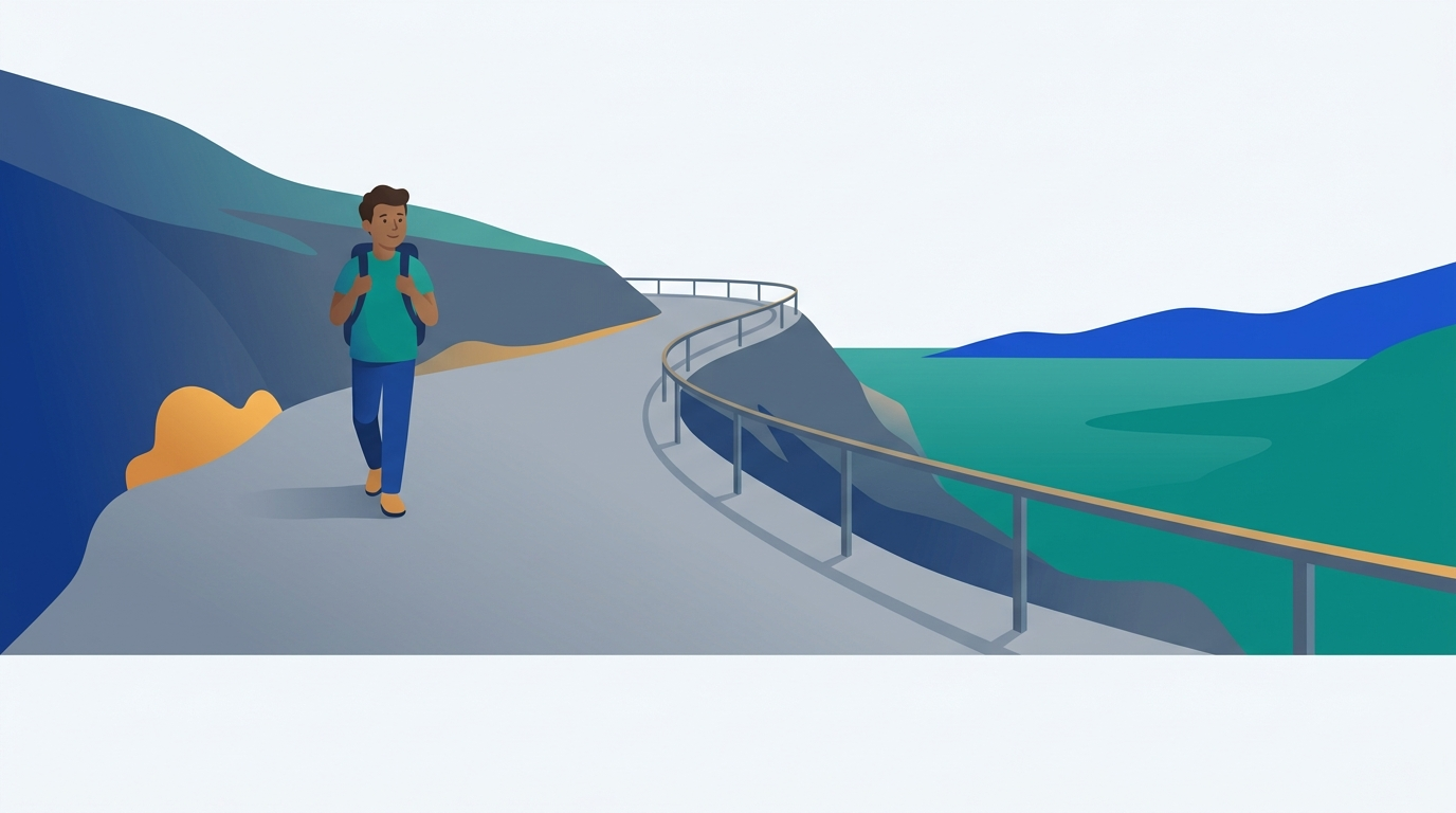 A hiker walks along the inner side of a wide mountain path, far from the guardrail at the cliff edge.